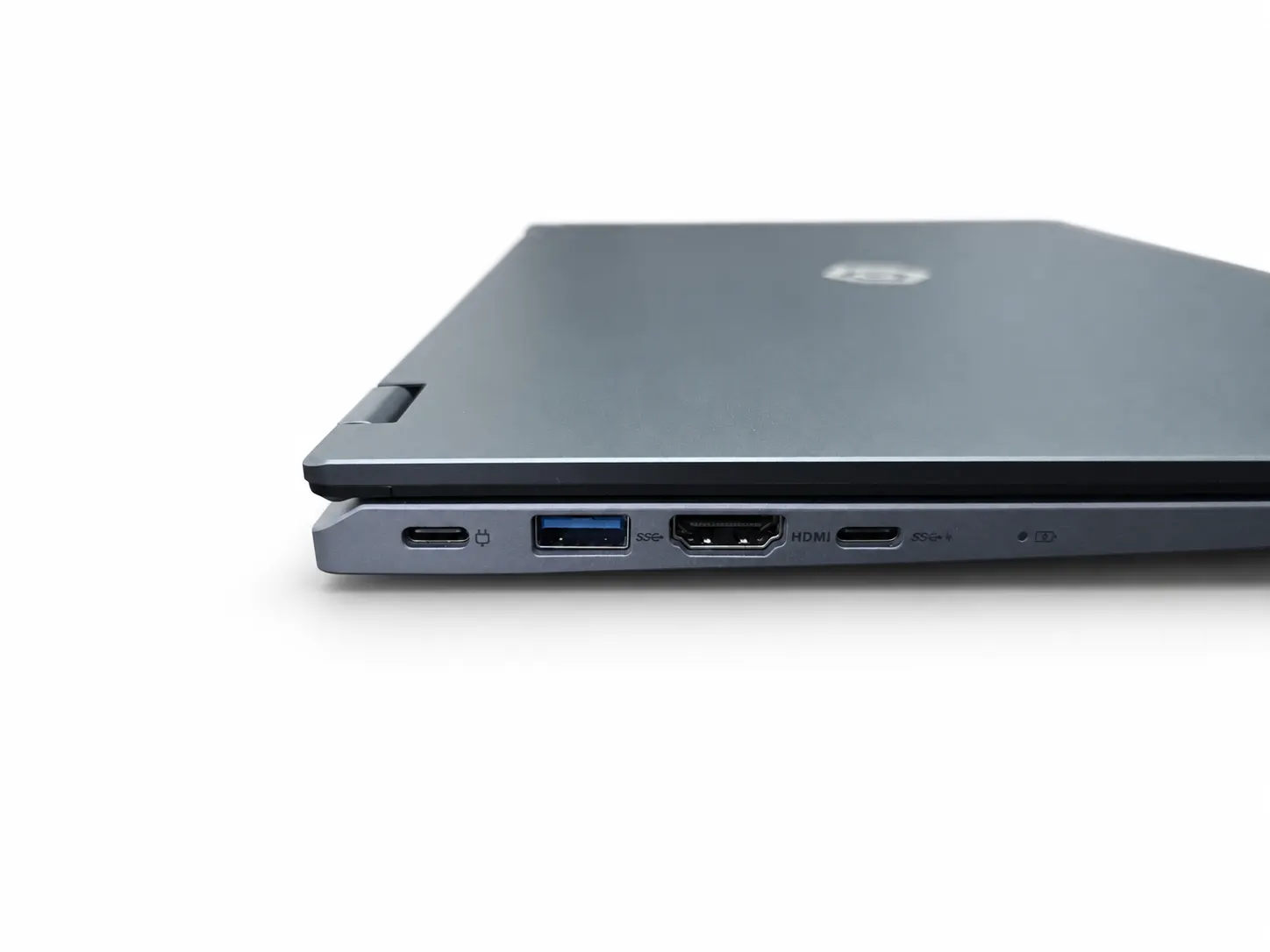 The closed laptop in profile, showing the USB, HDMI and USB-C ports on that side