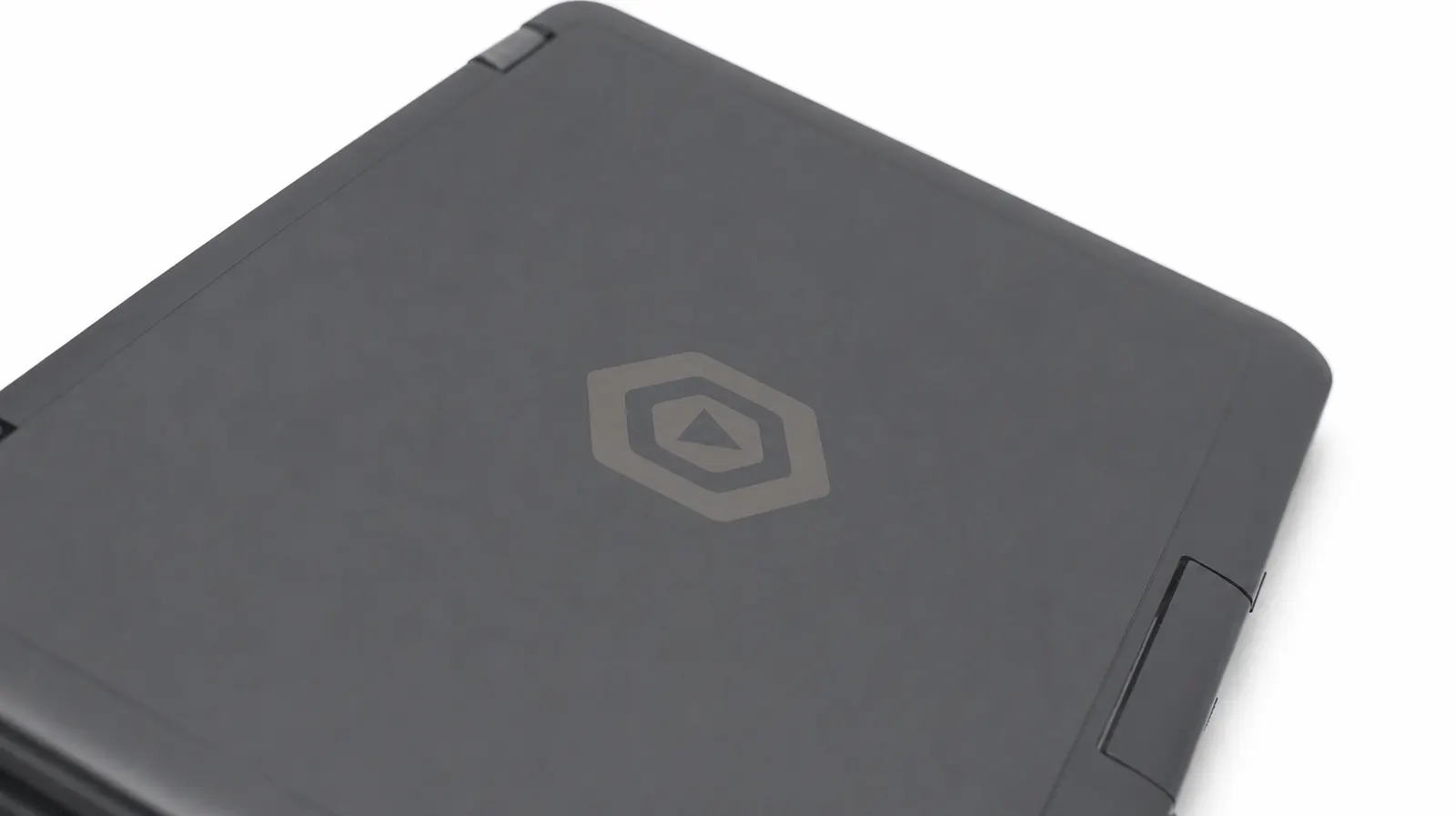 The laptop closed, in black, seen at an angle